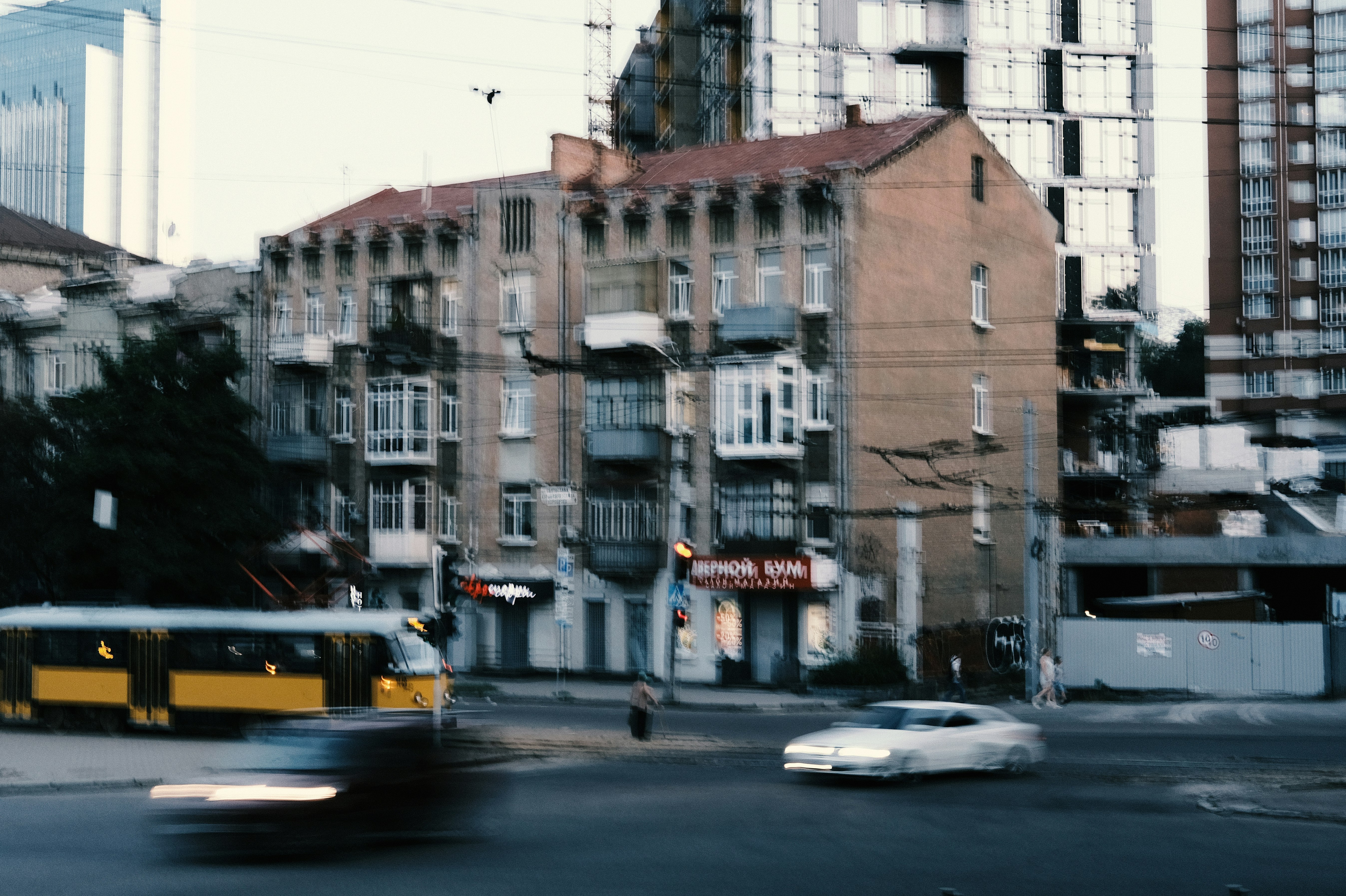 cars parked beside brown concrete building during daytime